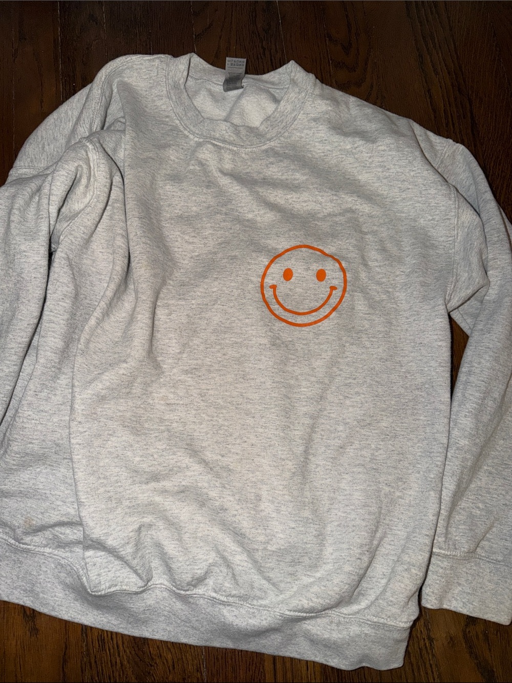 Light Gray Sweatshirt with Orange Smile Graphic